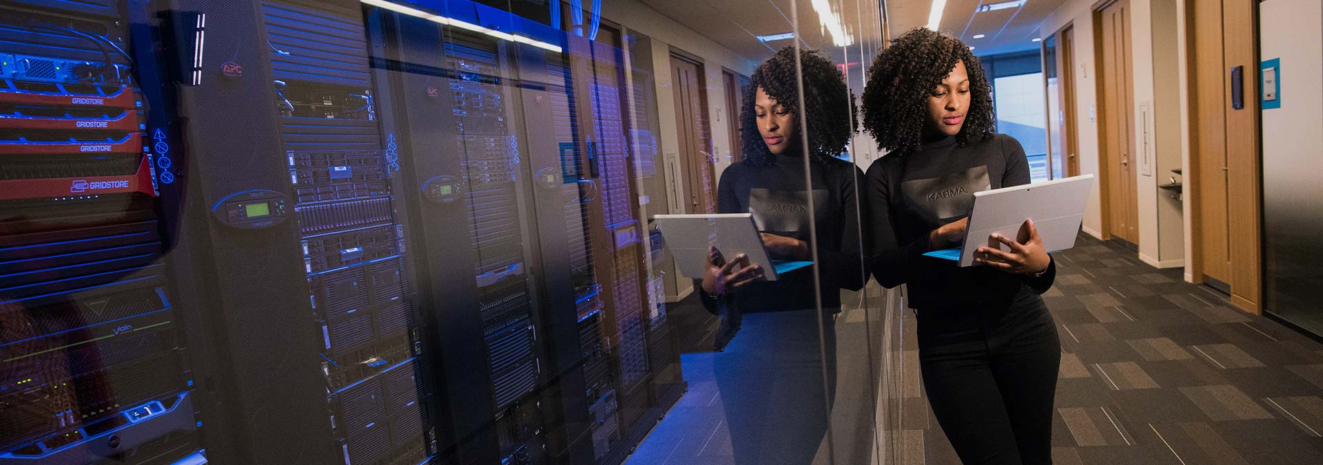 woman-standing-using-a-laptop-near-a-server-technology-africa